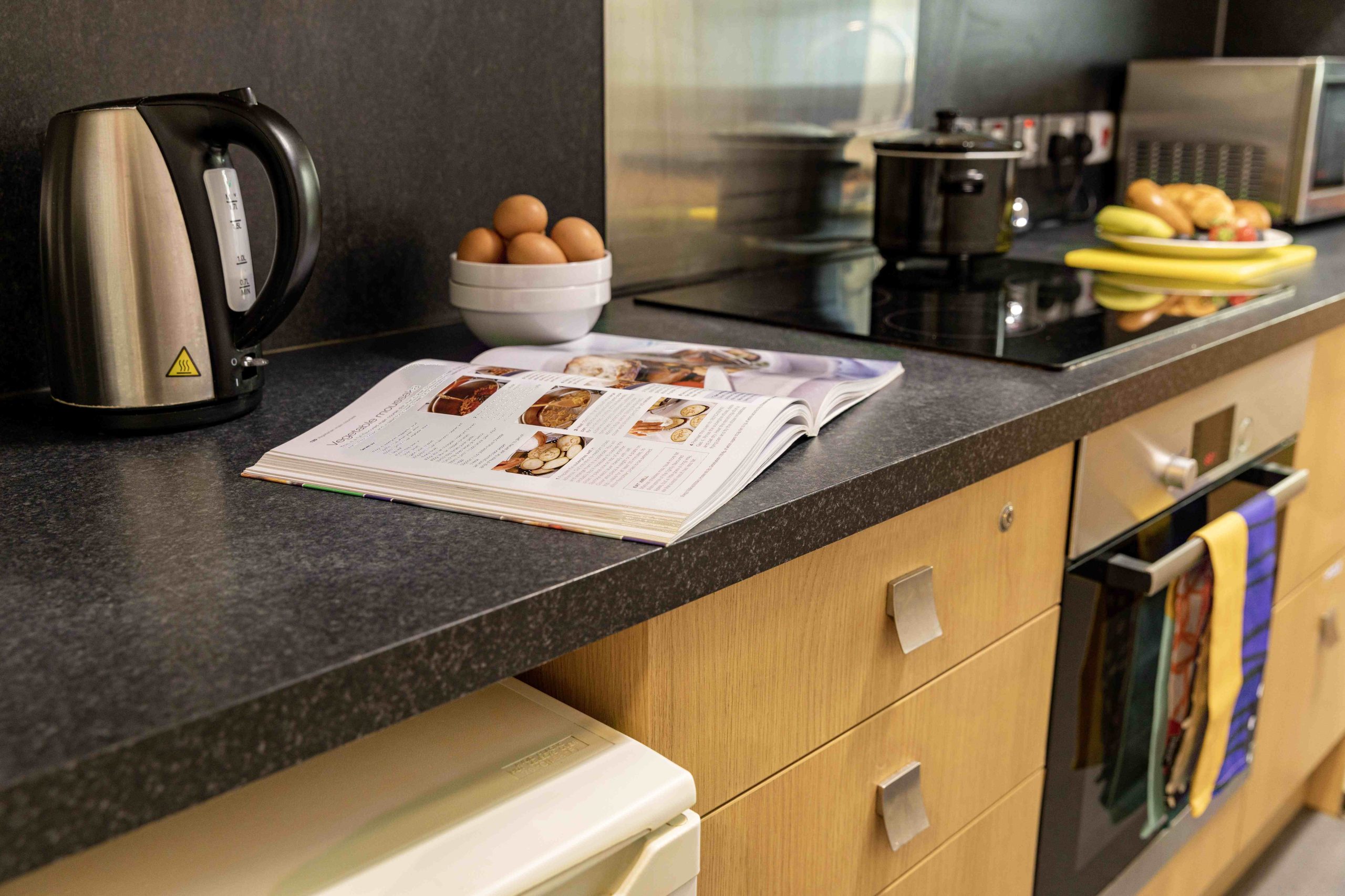 An open cookbook on a kitchen counter at The Copse