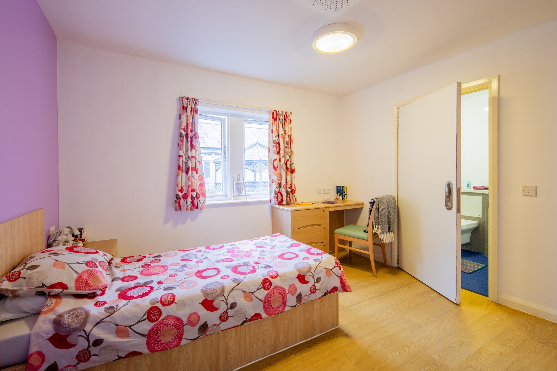 A bedroom with an en suite bathroom at Spring Wood Lodge